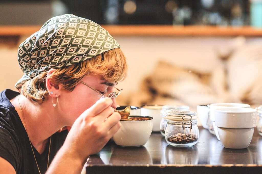 Q grader tests coffee for aroma during cupping